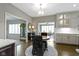 Sunlit breakfast nook featuring a round table and decorative chairs that flows to the kitchen at 13 Ridgeline Dr, Brownsburg, IN 46112