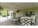 View of the covered deck featuring brick siding, comfortable chairs, and an outdoor grill at 13 Ridgeline Dr, Brownsburg, IN 46112