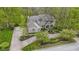Aerial view of a charming brick house with landscaped gardens and a lush green lawn, surrounded by mature trees at 13 Ridgeline Dr, Brownsburg, IN 46112