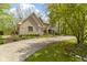 Charming two-story home showcasing a landscaped yard, mature trees, and a paved driveway leading to a lush landscape at 13 Ridgeline Dr, Brownsburg, IN 46112