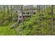 Aerial view of a home on a wooded lot with a multi-level deck and lush landscaping at 13 Ridgeline Dr, Brownsburg, IN 46112