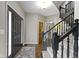 Inviting foyer with a black front door, hardwood floors, and staircase with elegant black railings at 13 Ridgeline Dr, Brownsburg, IN 46112