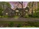 Inviting two-story brick home featuring professional landscaping, walkway, and a large driveway surrounded by lush greenery at 13 Ridgeline Dr, Brownsburg, IN 46112