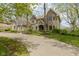 Beautiful two-story home showcasing a large driveway surrounded by mature landscaping and natural tree buffer at 13 Ridgeline Dr, Brownsburg, IN 46112