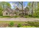 Charming two-story brick home featuring a large driveway surrounded by mature landscaping and natural tree buffer at 13 Ridgeline Dr, Brownsburg, IN 46112