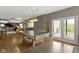Recreation room featuring a pool table, bar seating, and access to an outdoor deck at 13 Ridgeline Dr, Brownsburg, IN 46112