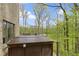 Exterior deck with hot tub and an outdoor grill with an expansive wooded view at 13 Ridgeline Dr, Brownsburg, IN 46112