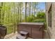 Deck with hot tub and stairs overlooking the wooded backyard at 13 Ridgeline Dr, Brownsburg, IN 46112