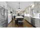 Bright and modern kitchen with stainless steel appliances, hardwood floors, and a large center island at 13 Ridgeline Dr, Brownsburg, IN 46112