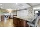 Updated kitchenette showcasing a stone backsplash, modern appliances, and a functional center island at 13 Ridgeline Dr, Brownsburg, IN 46112