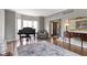 Elegant living room with hardwood flooring, bay window, piano, and comfortable seating at 13 Ridgeline Dr, Brownsburg, IN 46112