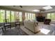 Bright living room featuring a cozy fireplace, large windows with nature views, and comfortable seating at 13 Ridgeline Dr, Brownsburg, IN 46112
