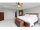 Spacious main bedroom with a tray ceiling, plush carpet, wooden furniture, and walk-in closet at 13 Ridgeline Dr, Brownsburg, IN 46112