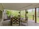 Covered porch with furniture, hanging plants, and a view of the lush landscaping at 13 Ridgeline Dr, Brownsburg, IN 46112