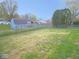 Fenced backyard features a large grassy lawn with a storage shed on the property at 1314 Brookside S Dr, Columbus, IN 47201