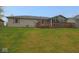 Large backyard featuring a wooden deck, sunroom, and well-maintained lawn at 1314 Brookside S Dr, Columbus, IN 47201