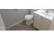 A bathroom features a toilet, and white vanity with light gray walls at 1314 Brookside S Dr, Columbus, IN 47201