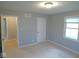 A sunny bedroom features neutral walls, carpeted floors, and a window at 1314 Brookside S Dr, Columbus, IN 47201