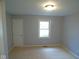 A bedroom has neutral-colored walls, carpeted flooring, and a window for natural light at 1314 Brookside S Dr, Columbus, IN 47201