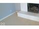 Close-up of a white-painted brick fireplace with neutral carpeting at 1314 Brookside S Dr, Columbus, IN 47201