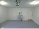 Spacious garage with modern lighting, water heater, and utility door to backyard at 1314 Brookside S Dr, Columbus, IN 47201