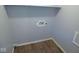 Convenient laundry room with wood-look flooring and wall-mounted utility connections at 1314 Brookside S Dr, Columbus, IN 47201
