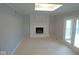 Cozy living room featuring a white painted brick fireplace and french doors at 1314 Brookside S Dr, Columbus, IN 47201