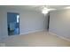 Open-concept living room featuring neutral carpet and a view into the kitchen at 1314 Brookside S Dr, Columbus, IN 47201