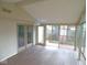 Bright sun room features wood-look flooring and glass windows with views to the outside deck at 1314 Brookside S Dr, Columbus, IN 47201
