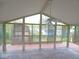 Bright sunroom featuring a ceiling fan, wood flooring, and many windows at 1314 Brookside S Dr, Columbus, IN 47201