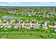 Scenic aerial view of the neighborhood featuring ponds and well-maintained lawns stretching into the horizon at 13728 Oliver Ln, Carmel, IN 46074