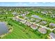 Picturesque aerial view of a community with lush lawns, tranquil ponds, and homes with manicured landscaping at 13728 Oliver Ln, Carmel, IN 46074