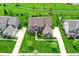 Aerial view shows a home with manicured landscaping, a spacious lawn, and mature trees in a Gathering-friendly neighborhood at 13728 Oliver Ln, Carmel, IN 46074