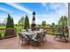 Picturesque view from the back deck featuring comfortable seating, an umbrella, and scenic landscaping at 13728 Oliver Ln, Carmel, IN 46074