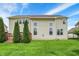Expansive backyard featuring mature trees, a well-maintained lawn, and a wooden deck for outdoor enjoyment at 13728 Oliver Ln, Carmel, IN 46074