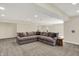 Finished basement features a large sectional sofa and neutral carpeting at 13728 Oliver Ln, Carmel, IN 46074