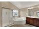 Bathroom with a corner tub, a glass enclosed shower and double vanity at 13728 Oliver Ln, Carmel, IN 46074