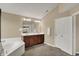 Bright bathroom features a double vanity, soaking tub, and neutral color palette at 13728 Oliver Ln, Carmel, IN 46074