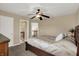 Cozy bedroom features neutral walls, a ceiling fan, and a connecting bathroom at 13728 Oliver Ln, Carmel, IN 46074