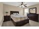 Warm and inviting bedroom featuring neutral walls, ceiling fan, and dark wood furniture at 13728 Oliver Ln, Carmel, IN 46074