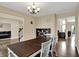 Elegant dining room features a dark wood table with white chairs, chandelier, and seamless flow to other living spaces at 13728 Oliver Ln, Carmel, IN 46074