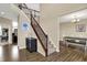 Inviting foyer with hardwood floors, staircase with wood railing, and views into the dining area at 13728 Oliver Ln, Carmel, IN 46074