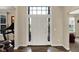 Bright foyer showcases a white front door with sidelights, hardwood floors, and views into adjacent rooms at 13728 Oliver Ln, Carmel, IN 46074