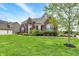 Charming brick home features a well-manicured lawn and attractive landscaping, enhancing its curb appeal at 13728 Oliver Ln, Carmel, IN 46074