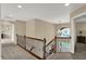 Upstairs hallway overlooking the entryway with a wrought iron railing at 13728 Oliver Ln, Carmel, IN 46074