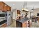 Spacious kitchen has stainless appliances, granite counters, and views to another room at 13728 Oliver Ln, Carmel, IN 46074