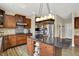 Gourmet kitchen with stainless steel appliances, a granite countertop island, and ample cabinet space for storage at 13728 Oliver Ln, Carmel, IN 46074