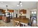Eat-in kitchen featuring granite countertops, stainless steel appliances, and an adjacent dining area at 13728 Oliver Ln, Carmel, IN 46074