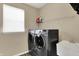 Laundry room features a gray washer and dryer, utility sink, and wire shelving at 13728 Oliver Ln, Carmel, IN 46074