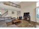 Cozy living room with hardwood floors, a fireplace, and plenty of natural light, with a soaring two-story ceiling at 13728 Oliver Ln, Carmel, IN 46074